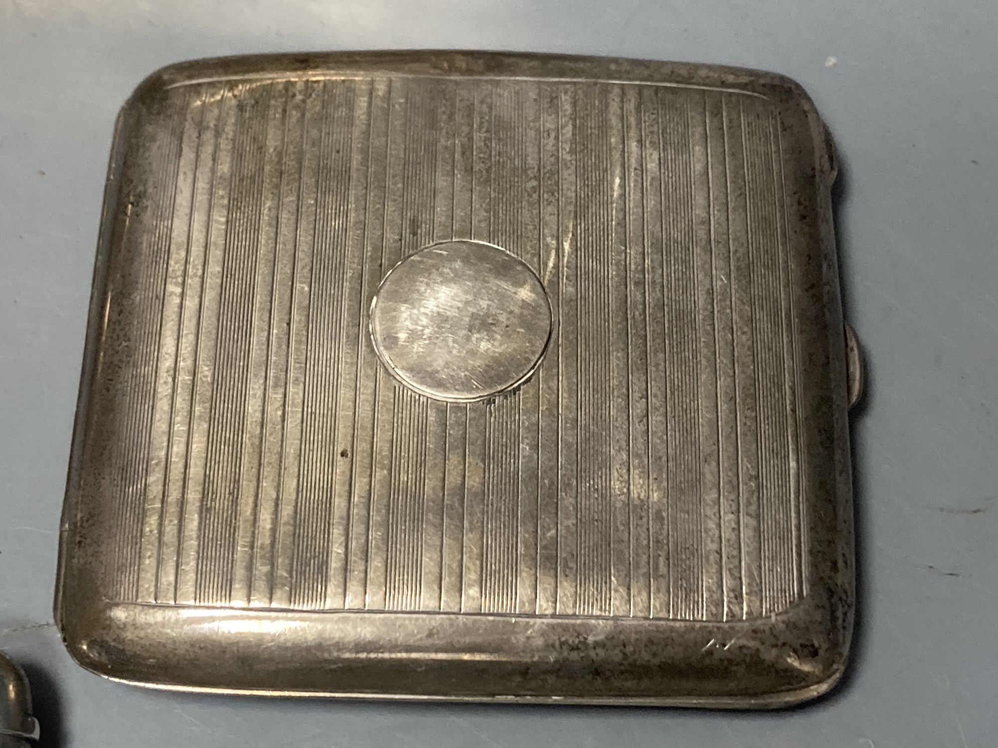 A silver cigarette box, silver cigarette case, four vestas including two silver, a continental dish and a toilet jar.